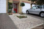 Scottish beach cobbles inset into mortar bed with planting pockets edging with sandstone setts 